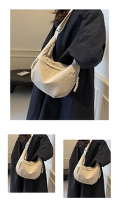 Close-up of beige dumpling crossbody bag featuring woven rope zipper and pleated texture