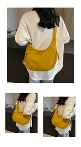 Detail view of mustard yellow dumpling bag showing durable nylon fabric and woven zipper pull