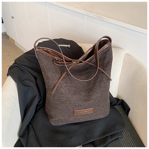 Chic dark brown woven tote bag with premium leather trim and minimalist ribbon detail