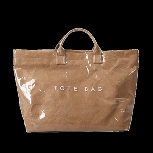 Detail of waterproof transparent PVC tote bag with brown tyvek paper texture and text