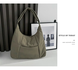 Detail view of large olive green hobo bag with wide shoulder strap and soft nylon texture