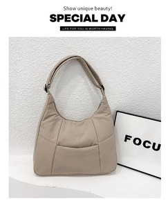 Detail view of beige crossbody bag with visible stitching and adjustable strap buckle