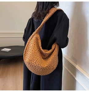 Vue détaillée du sac à bandoulière en suédine à motif léopard porté par un mannequin