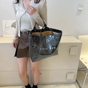 Glossy black large capacity tote bag with white TOTE BAG text print and long shoulder straps