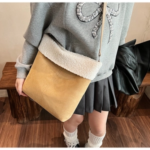 Detail of crossbody bag in yellow suede fabric with white fleece trim design