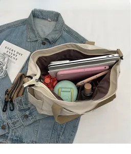 Detailed interior view showing laptop compartment and pockets of the large canvas tote bag