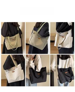 Detail view of khaki, beige, white and black canvas tote bags with adjustable straps
