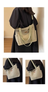 Detail view of large canvas tote bag with olive green straps and secure zipper closure