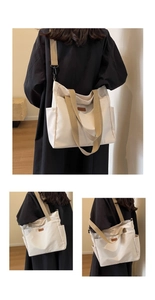 Detail of canvas tote bag showing side pocket, brown leather patch and khaki strap accents