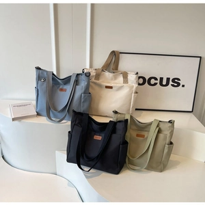 Detail showing high-capacity tote bags in blue, beige, black, and olive green colors