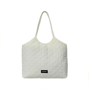 Chic cream white tote bag with heart-shaped quilting and a minimalist shoulder strap