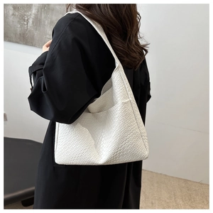 Detailed texture of white crocodile pattern leather on stylish minimalist shoulder tote bag