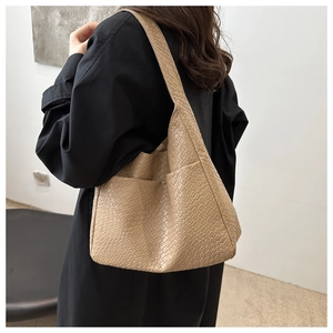 Close-up of beige woven texture tote bag featuring a practical side pocket and large capacity