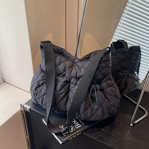 Chic black quilted cloud bag with wide shoulder strap and drawstring nylon fabric details