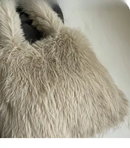 Close-up detail of soft faux fur fabric texture on the beige autumn shoulder bag