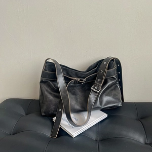 Vintage black PU leather shoulder bag with wide adjustable eyelet strap and retro texture