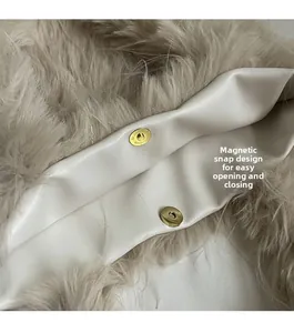 Detail of soft faux fur bag with golden magnetic snap closure for easy opening