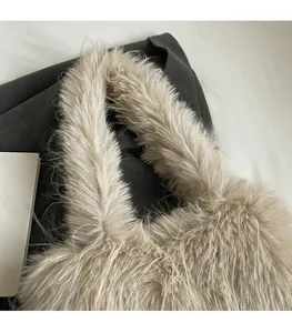 Detail of soft beige faux fur shoulder bag featuring a wide comfortable carry handle
