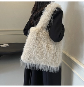Detail shot of the plush faux fur texture on this large cream white autumn shoulder bag