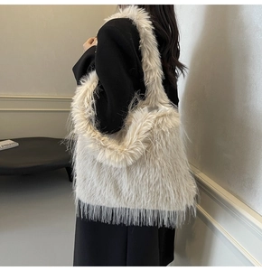 Detail showing the plush faux fur texture of the cream white oversized shoulder bag