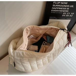 Detail view of large quilted bubble bag interior showing spacious storage and zip closure