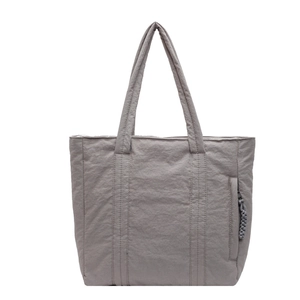 Fashionable grey fabric tote bag with water-resistant nylon texture and long handles