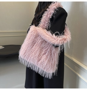 Detail of pink faux fur tote bag showing the fluffy texture and long shoulder strap