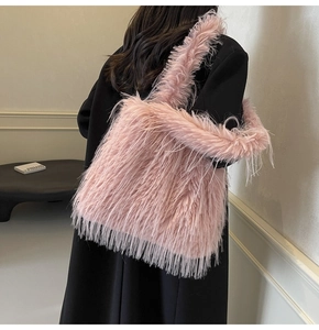 Detail of pink faux fur tote bag showing fluffy texture and long shoulder strap