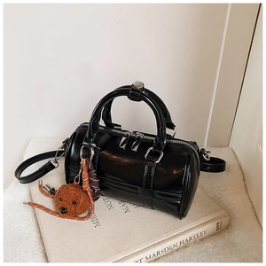 Minimalist black glossy PU leather Boston bag with a cute bear charm and silver hardware
