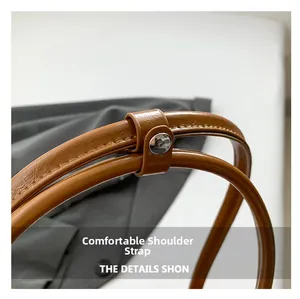 Detailed macro view of high-quality oil wax leather shoulder strap with silver rivet