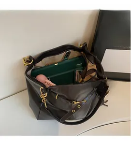 Macro shot of large capacity dark brown PU leather tote bag with various daily essentials
