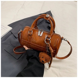 Chic vintage brown PU leather Boston bag with teddy bear charm and silver hardware