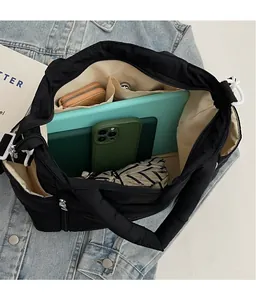Interior view of large black quilted tote bag showing multiple storage compartments