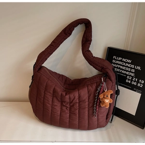 Deep burgundy quilted shoulder bag for women with a cute brown bear charm accessory