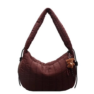 Quilted burgundy nylon hobo bag for women with plush bear charm and adjustable strap