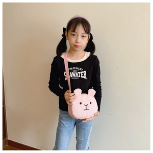 Detailed view of pink plush rabbit crossbody bag with lamb wool texture and ribbon strap