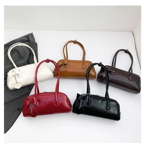 Five oil wax leather baguette bags with side bows and heart pendants in various colors