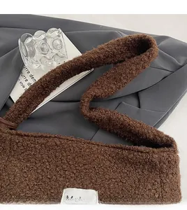 Close-up of brown fuzzy fleece tote bag showing wide shoulder strap detail and texture