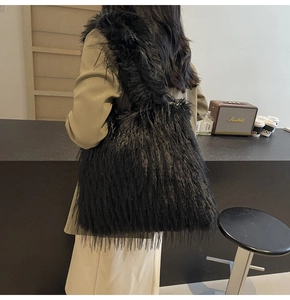 Detail of a black faux fur tote bag with long fluffy texture and spacious shoulder design