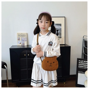 Detail showing plush brown bear crossbody bag for children with soft faux fur texture