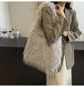 Detailed view of plush faux fur shoulder bag texture with soft grey premium material