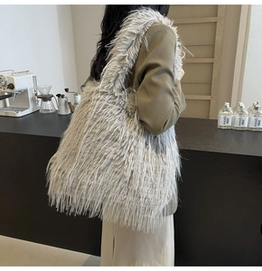 Detail of grey faux fur tote bag showing the fluffy texture and shoulder strap design