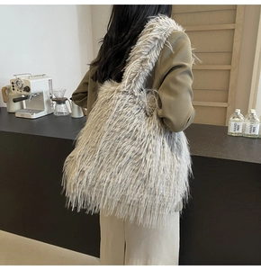 Fashionable faux fur tote bag in grey showing spacious design on a model back view