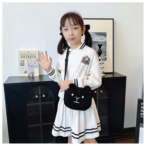 Detailed view of white long sleeve academy style dress with black stripes and embroidery