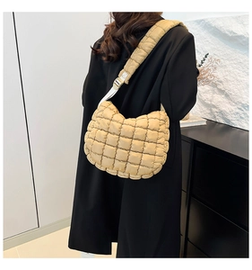 Quilted puffer bag detail featuring soft khaki nylon fabric and padded shoulder strap