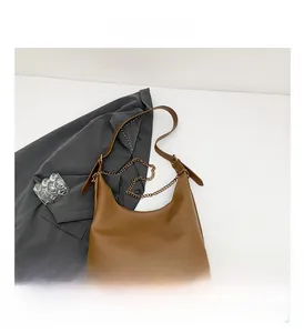 Top view of brown PU leather shoulder bag with fine gold chain and leather strap