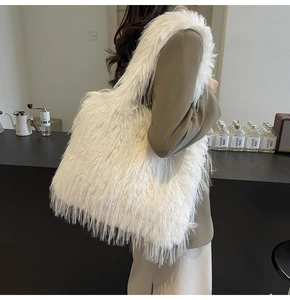 Detail of soft white faux fur tote bag showing the fluffy texture and wide shoulder strap