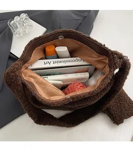 Detail view of a brown plush tote bag showing large capacity for books and cosmetics