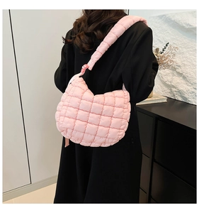 Detailed view of the light pink quilted cloud bag with padded wide shoulder straps