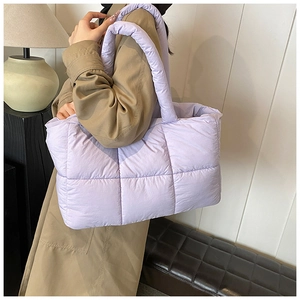 Detail of light purple quilted puffer tote bag with wide soft shoulder straps for women